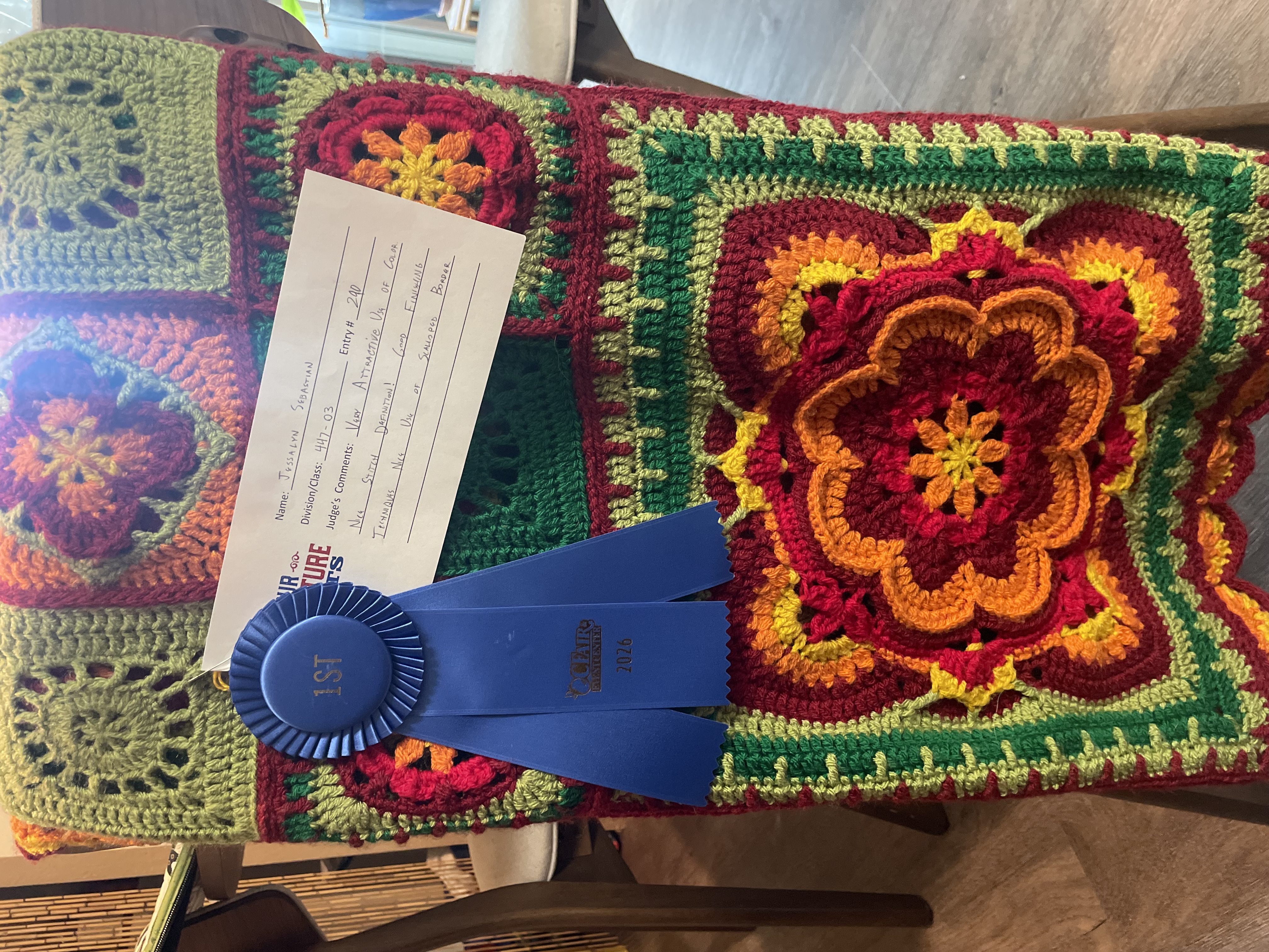 The blanket with its ribbon and judges' comments